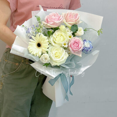small bouquet of pink,white roses,white gerbera daisy & other side fillers in white wrapping