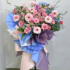 Opening flower tripod stand in blue wrapping with pink flowers
