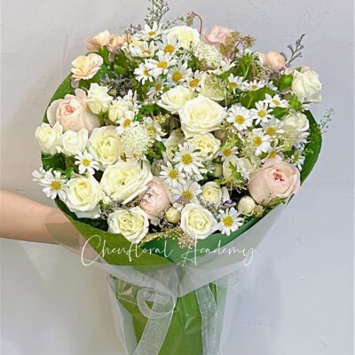 Pastel color flowers in green color wrapping bouquet