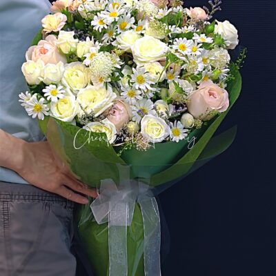 Pastel color flowers in green color wrapping bouquet