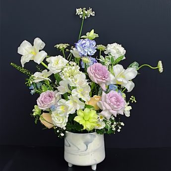 a vase of flower arrangement with Tulips and Roses